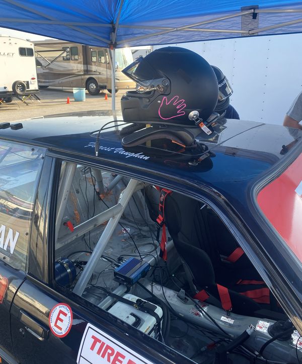 Race helmet with daughter's handprint on the E30 at VIR